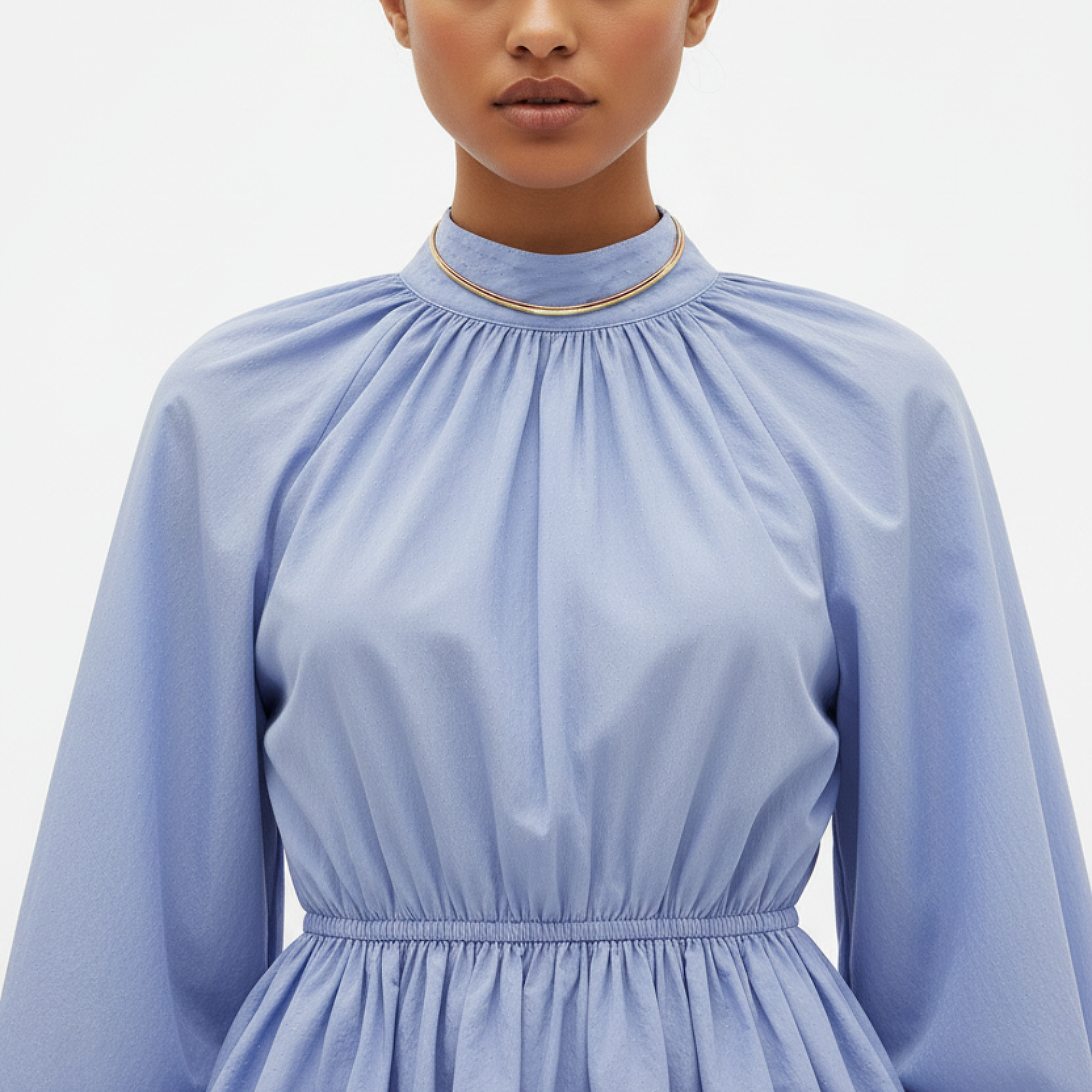 Light blue dress with long sleeves on a plain background