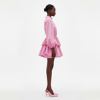 Woman wearing a pink dress on a white background