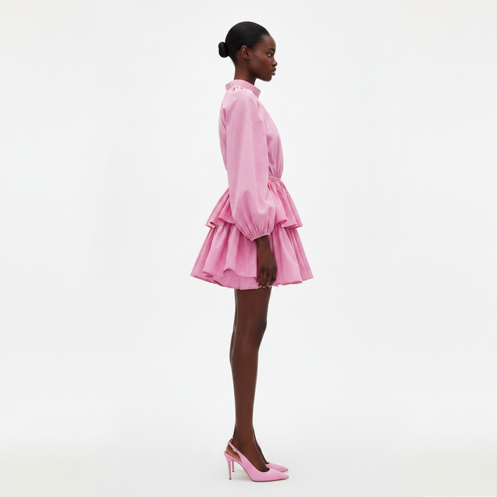 Woman wearing a pink dress on a white background