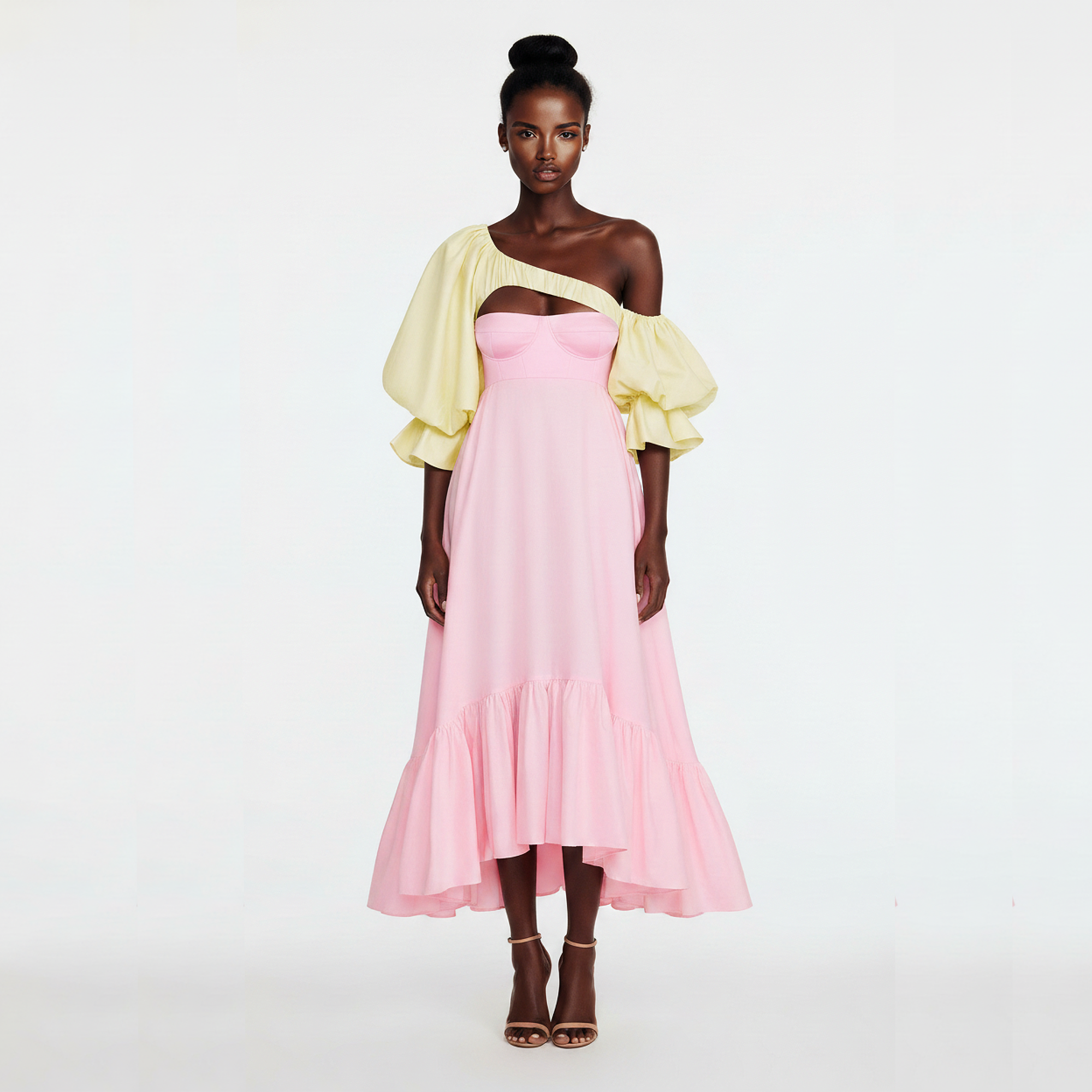 Woman wearing a pink dress with yellow sleeves on a white background