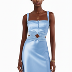 Woman wearing a light blue dress with cut-out design on a white background