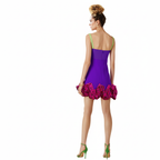 Woman wearing a purple dress with floral details on a white background