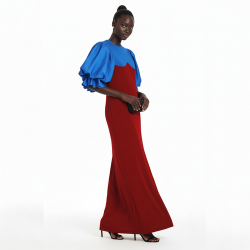 Woman wearing a red and blue dress on a white background