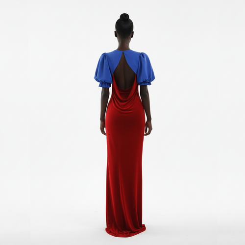 Woman wearing a red and blue dress with an open back on a white background