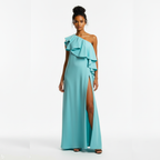 Woman wearing a turquoise one-shoulder gown with a slit on a white background