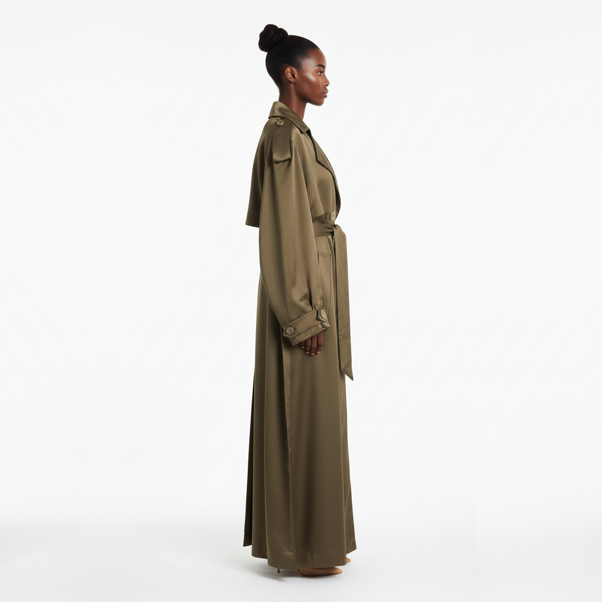 Woman wearing a long beige trench coat on a white background