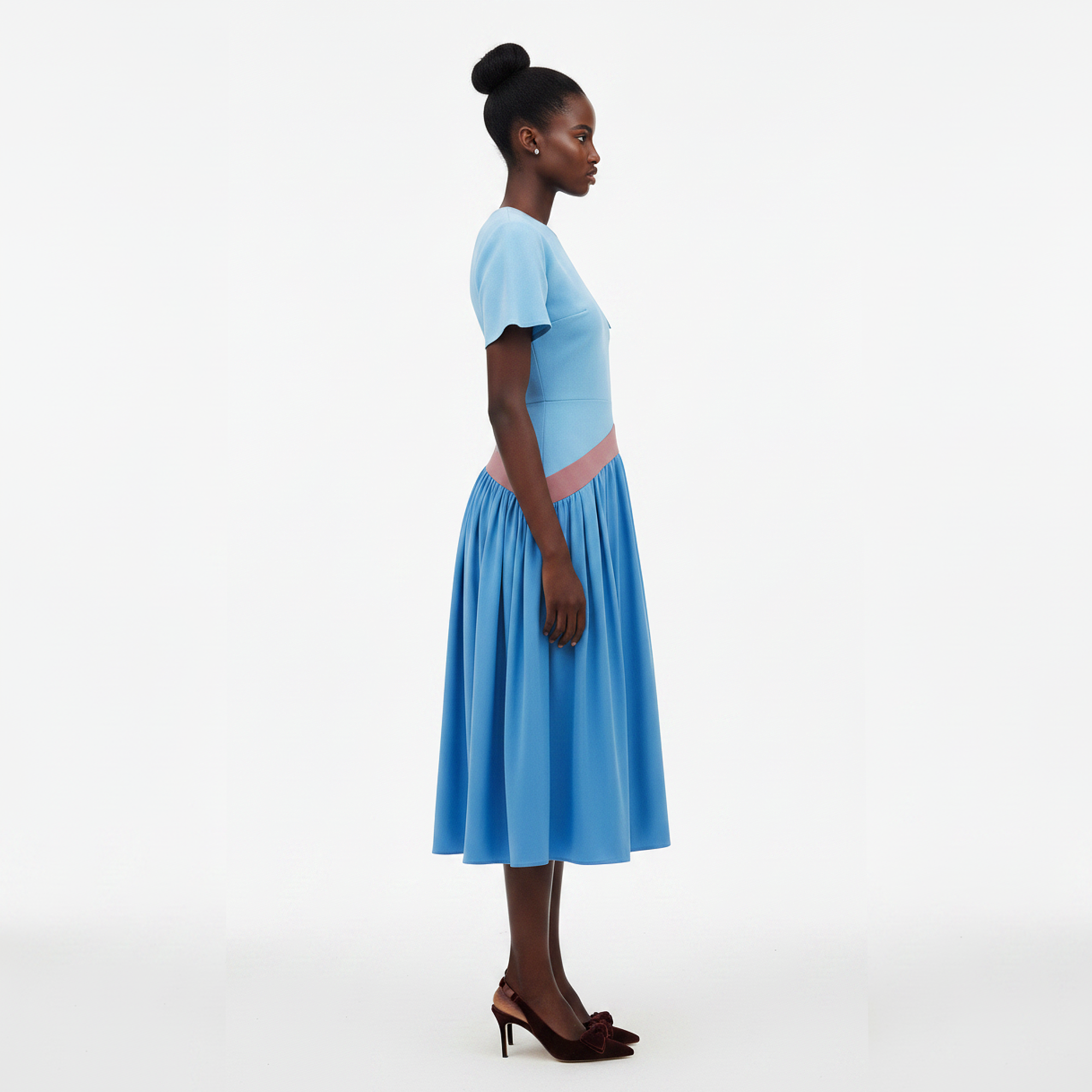 Woman wearing a blue dress with a white background