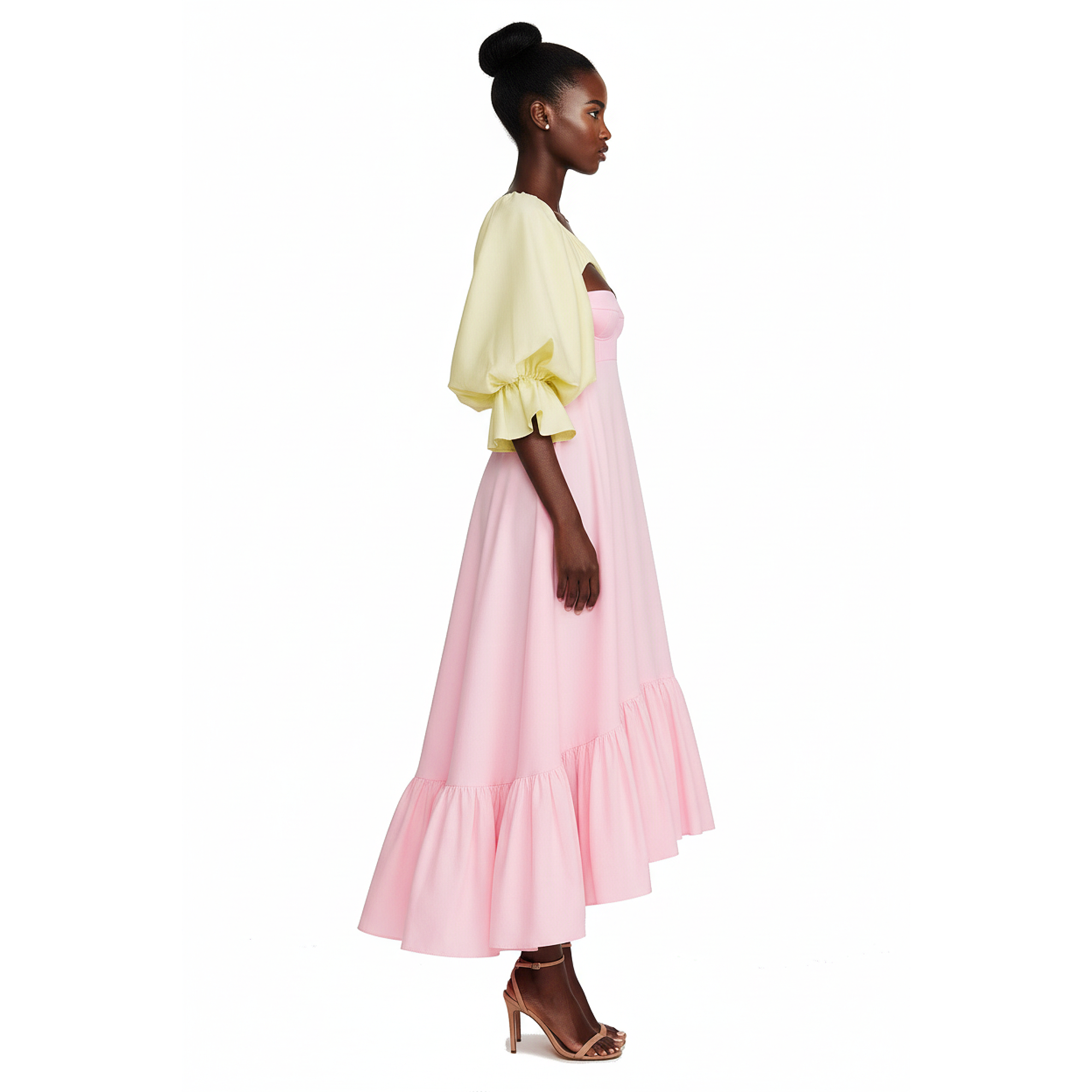 Woman wearing a light yellow top and pink skirt on a white background