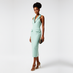 Woman wearing a light green dress with a white background