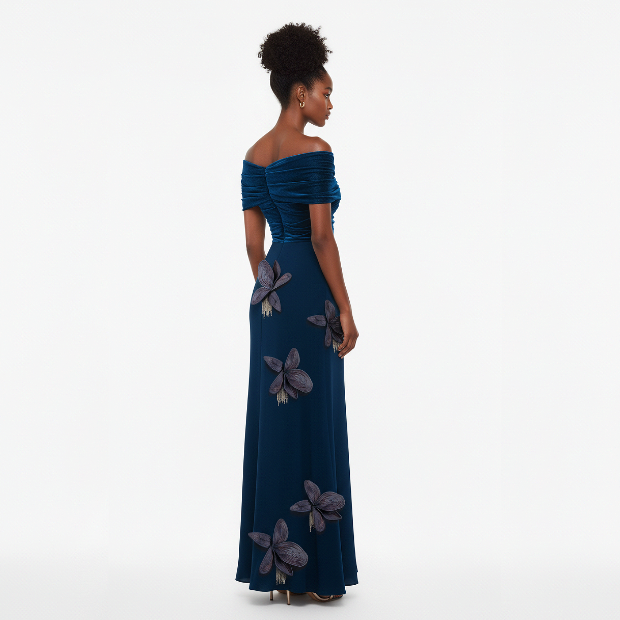 Woman wearing a blue off-shoulder gown with floral details on a white background