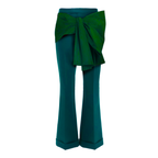 Teal pants with a large green bow on a white background