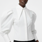 White blouse with puffed sleeves worn by a model on a white background