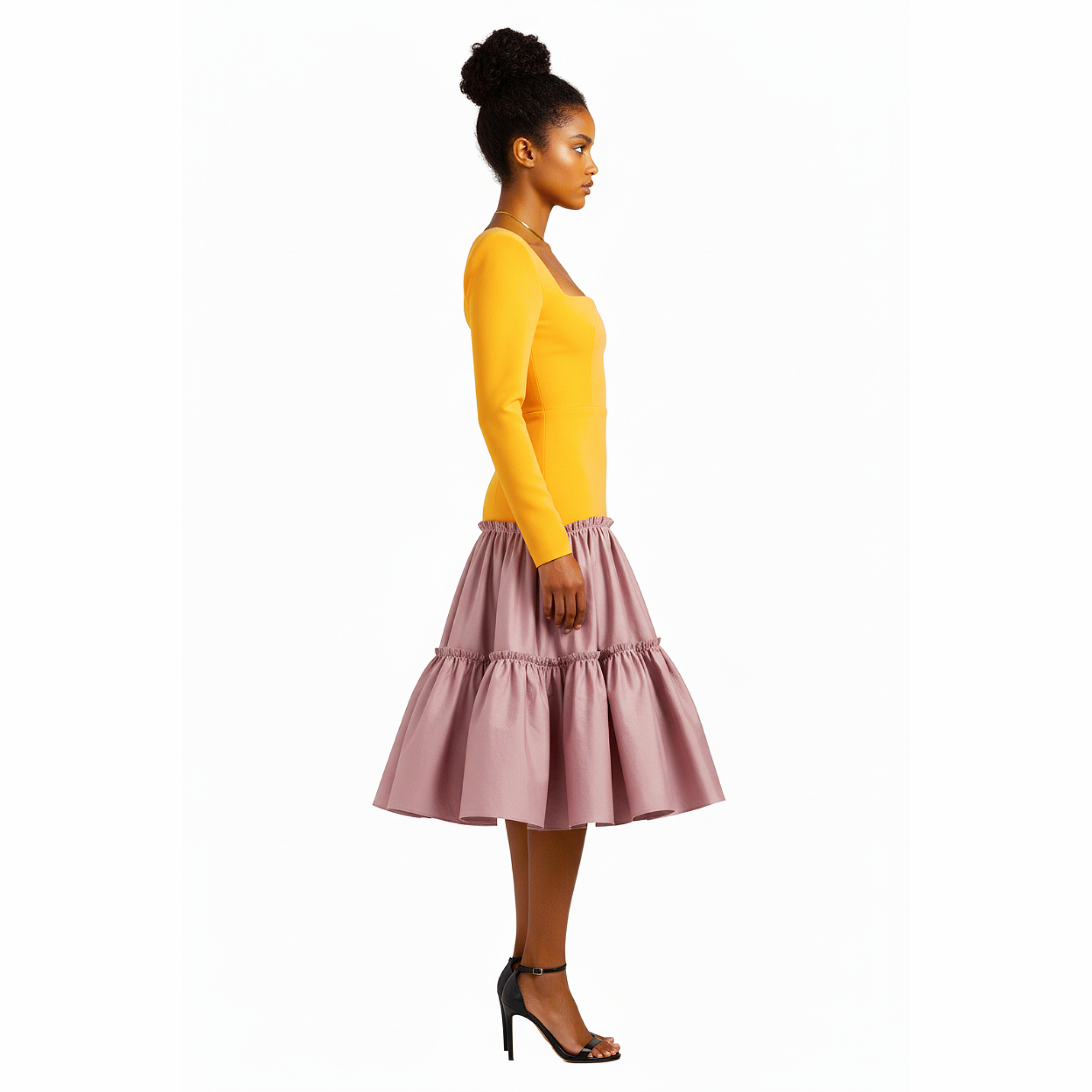 Woman wearing a yellow top and pink skirt on a white background